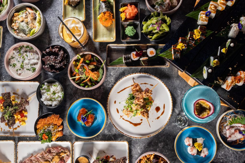 A diverse array of meticulously prepared dishes, beautifully showcasing the unique fusion of Japanese and Brazilian cuisines
